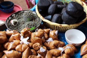 Groundnut paste and néré (black) for sale in market, Ghana. Neré is a local seasoning paste made from a wild tree. Credit: Bioversity International/C. Zanzanaini