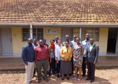 A group photo of the trainees and trainers with the site coordinator (Dr. Mukankusi, second from right-Front row) at the completion of the training.