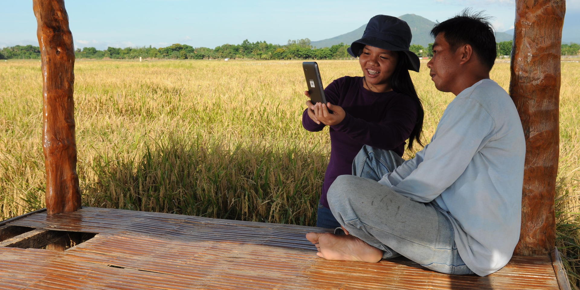 Extension officer and farmer in the Philippines using the rice crop manager