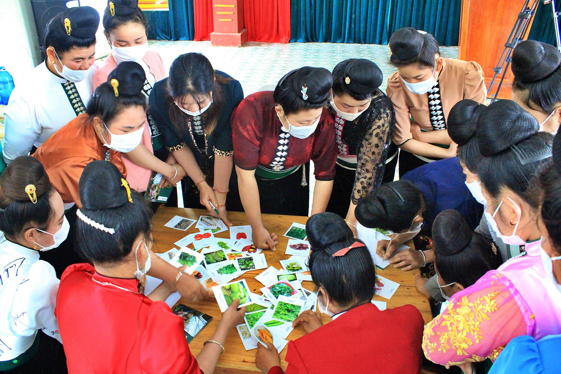 Women taking part in a food shopping game during a Diet Health Club meeting