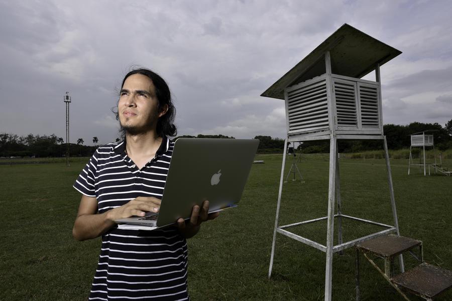 Julian while he checks data from a weather station