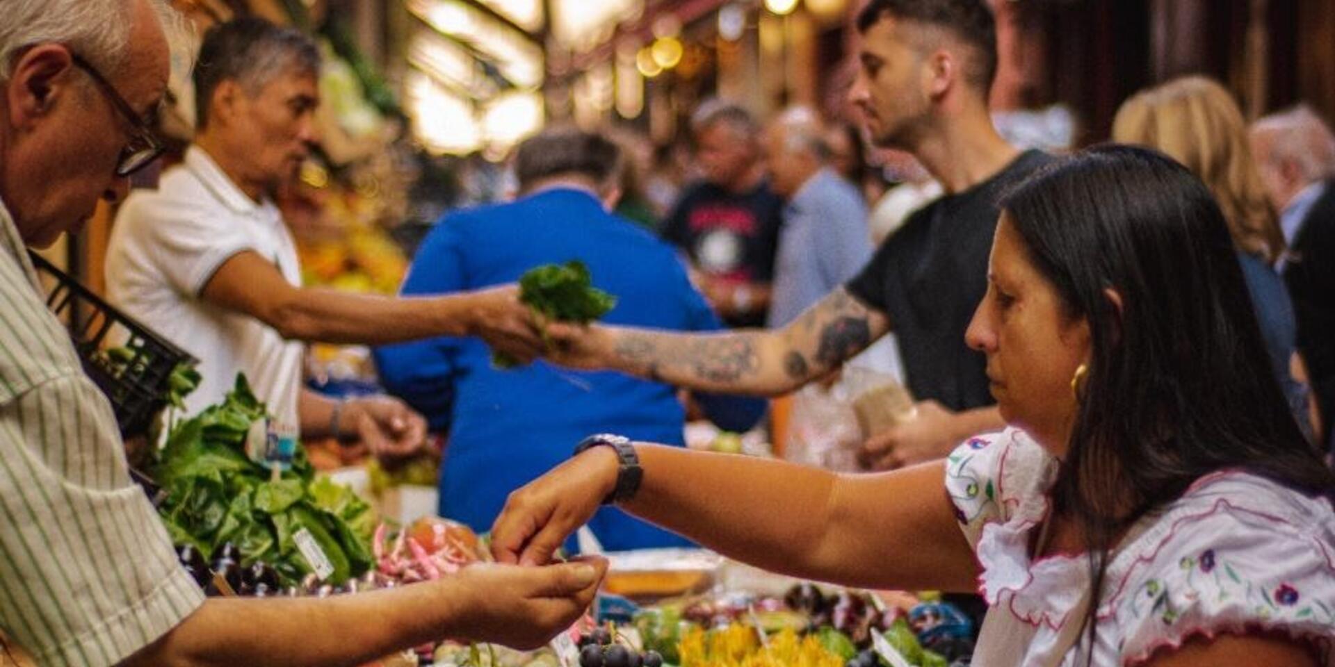 People buying vegetables at a food market