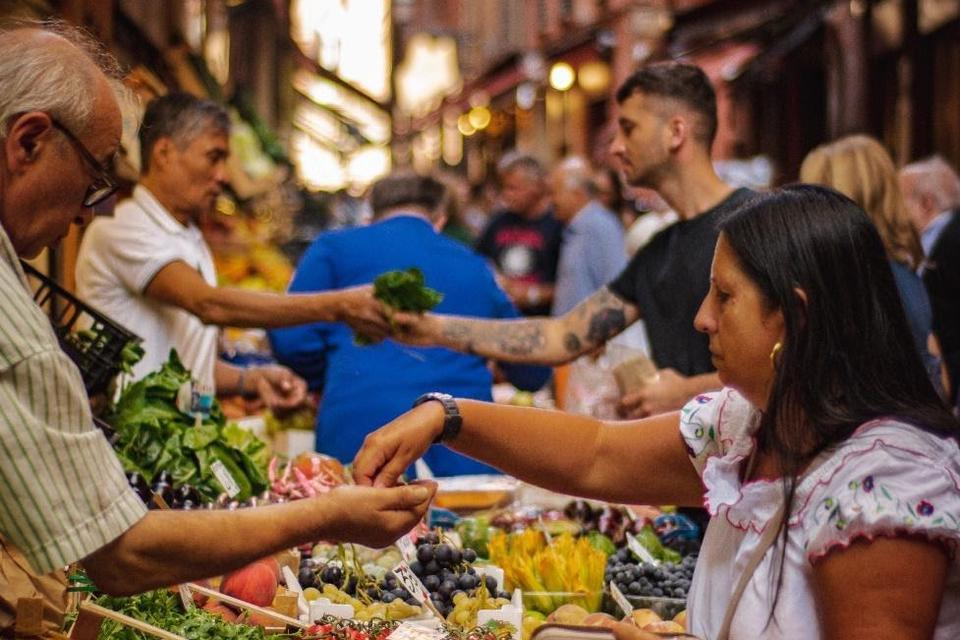 People buying vegetables at a food market